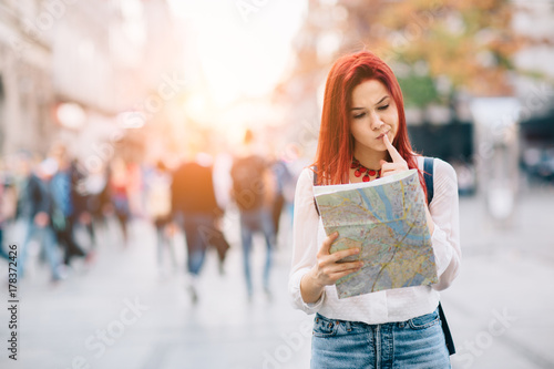 Young beautiful female traveler lost in the city 