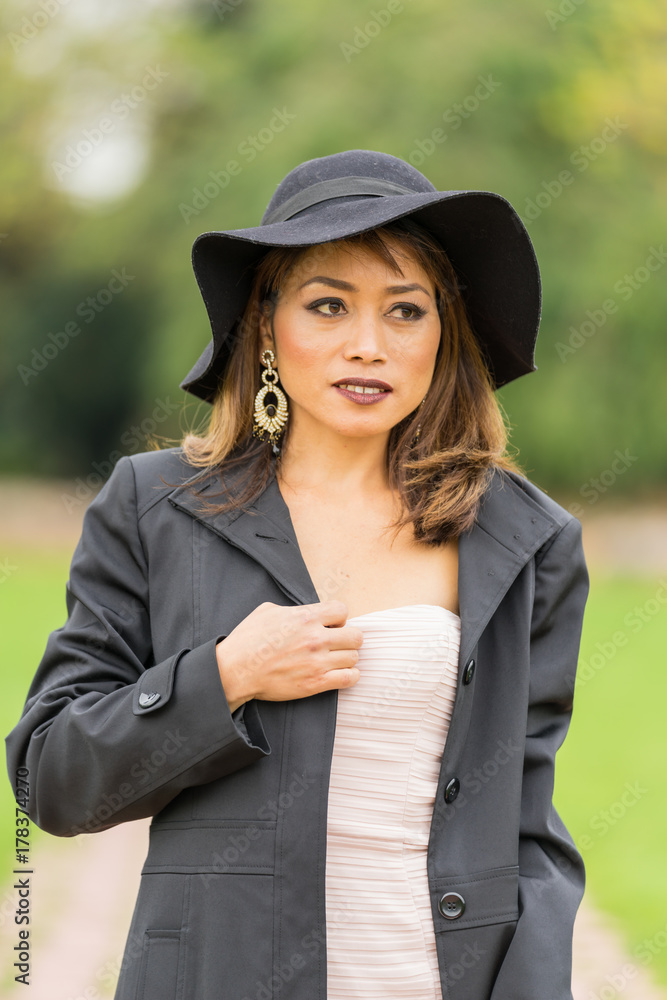 Filipino female model at Autumn time in a park during the daytime, with lush foliage all around. Filipino female model at Autumn time in a park during the daytime, with lush foliage all around.
