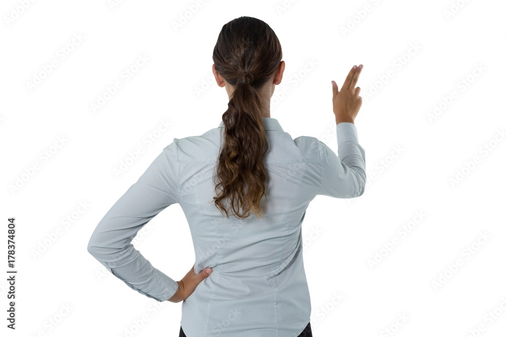 Female executive pressing an invisible virtual screen