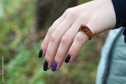 Manicured hands with wooden ring