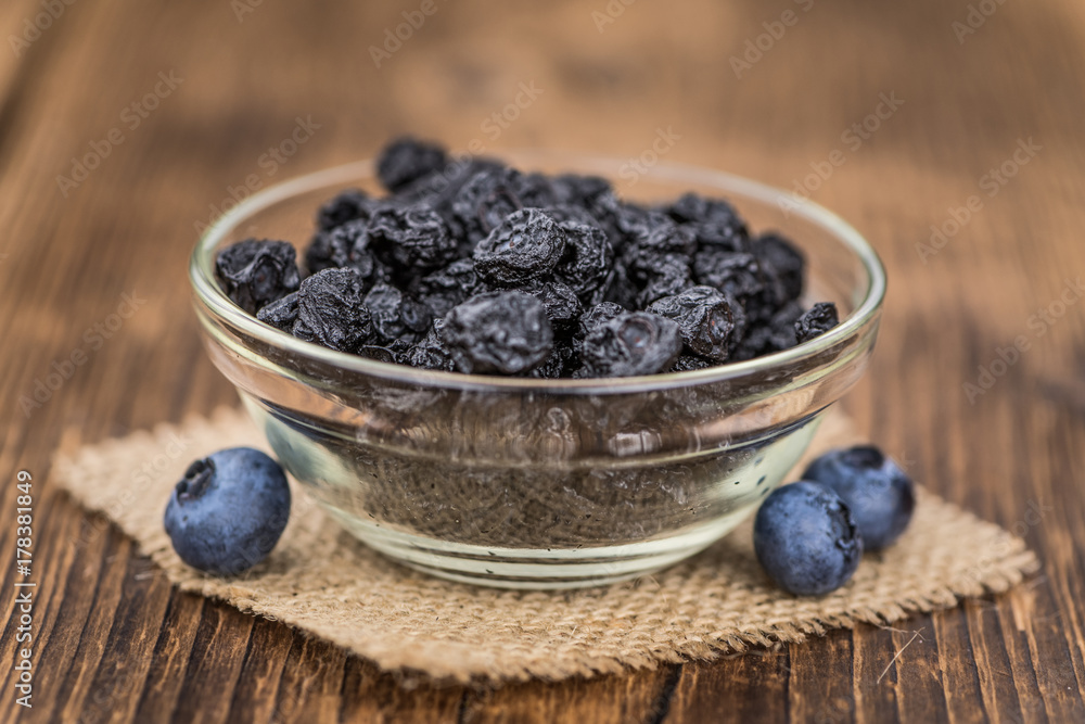 Dried Blueberries on wooden background; selective focus Dried Blueberries on wooden background; selective focus