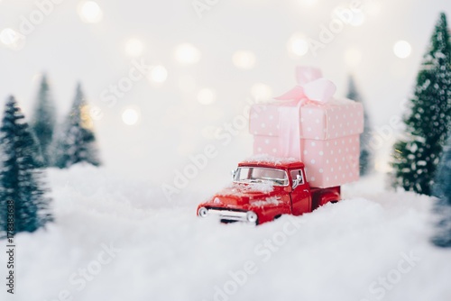 Toy pickup car carrying Christmas present