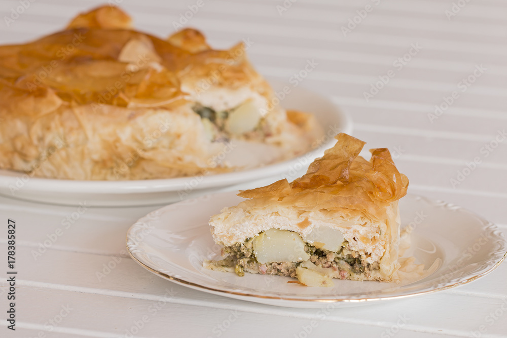 A slice of homemade vegetables and ricotta cheese timbale with filo pastry.