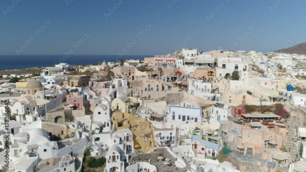 Aerial above white houses and famous old castle ruins, Santorini Island, Greece. Village of Oia Aerial above white houses and famous old castle ruins, Santorini Island, Greece. Village of Oia