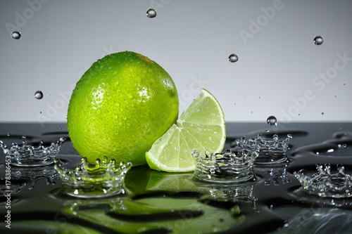Lime with raindrops on grey background