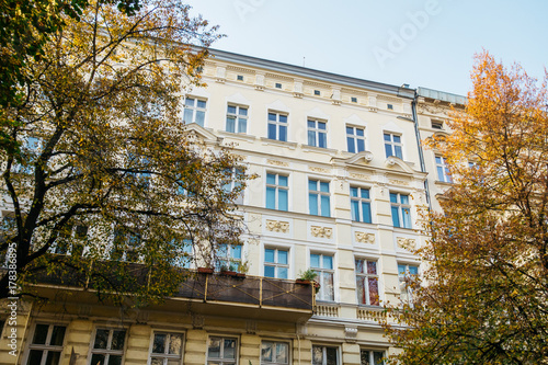 yellow facaded apartment complex in autumn © Robert Herhold