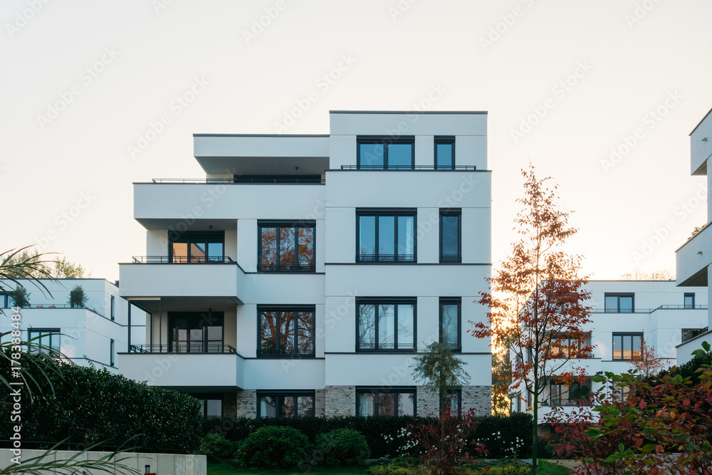 © Novanture - white apartment complex in the eve