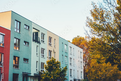 red, green and yellow townhouses in a row at autumn