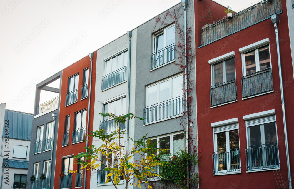 Obraz premium townhouses with different facades in color red, white and grey