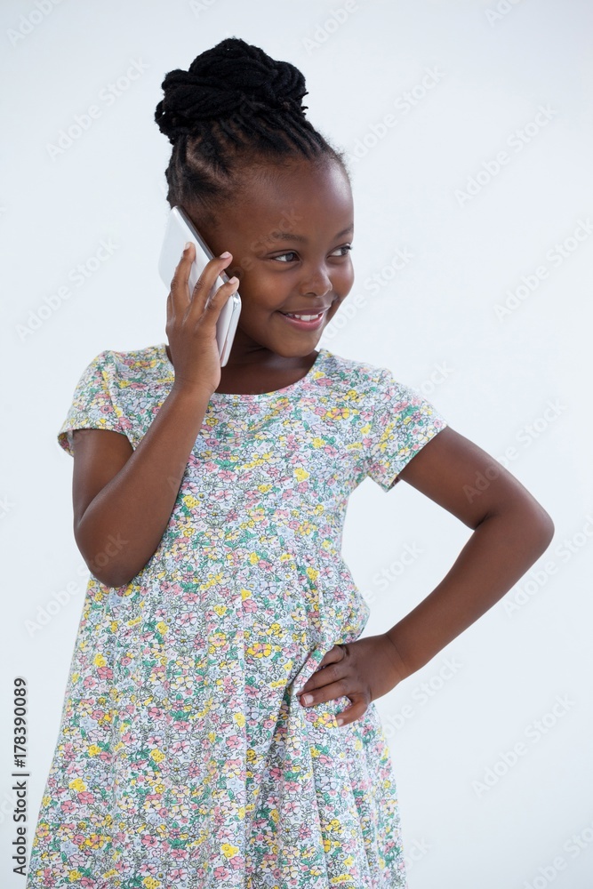 Smiling businesswoman with hand on hip talking on phone Smiling businesswoman with hand on hip talking on phone