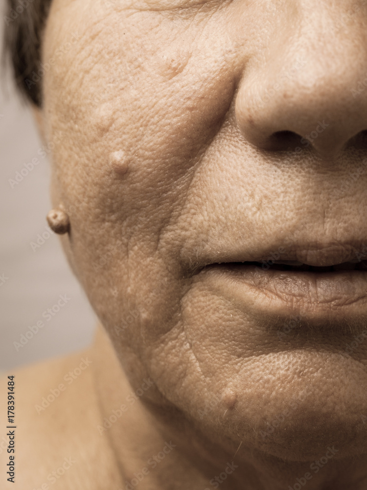 Obraz premium Elderly pensioner female half face portrait closeup