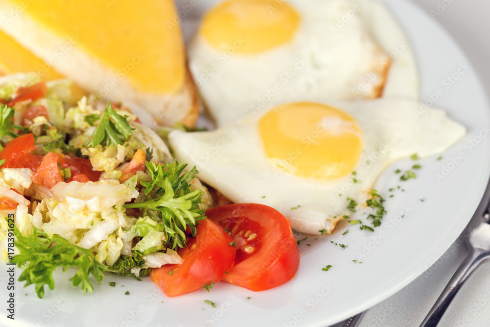Tasty brekfast. Fried eggs with salad and toast Tasty brekfast. Fried eggs with salad and toast