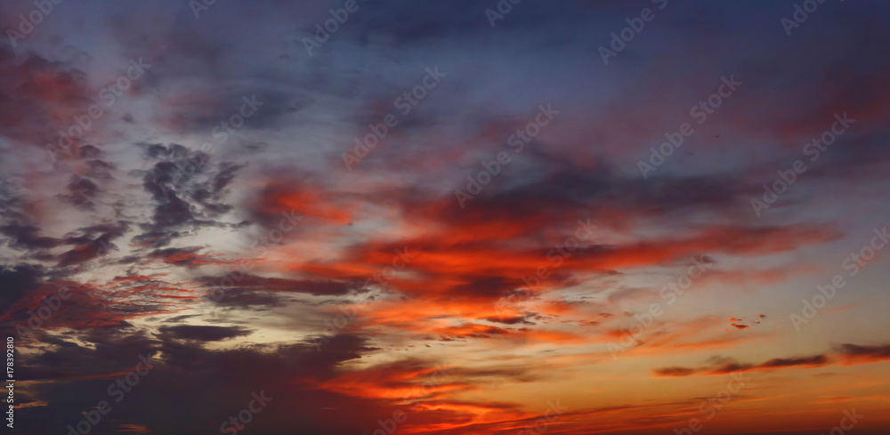 Colorful cloudy sky on sunset. Color blue red sky background