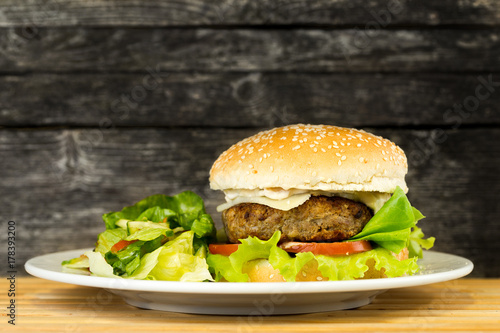 Delicous grilled beef burger on rustic background