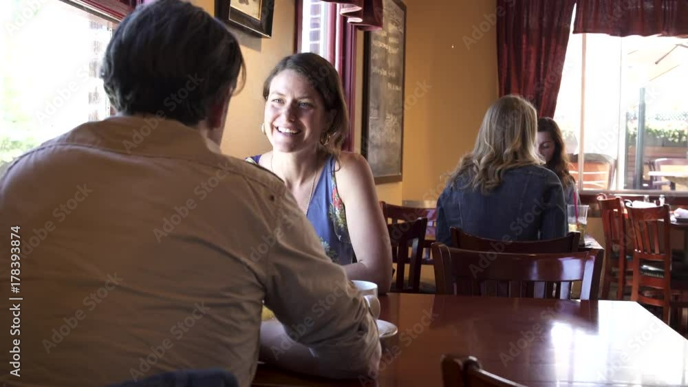 Medium shot of a couple eating in a restaurant Medium shot of a couple eating in a restaurant