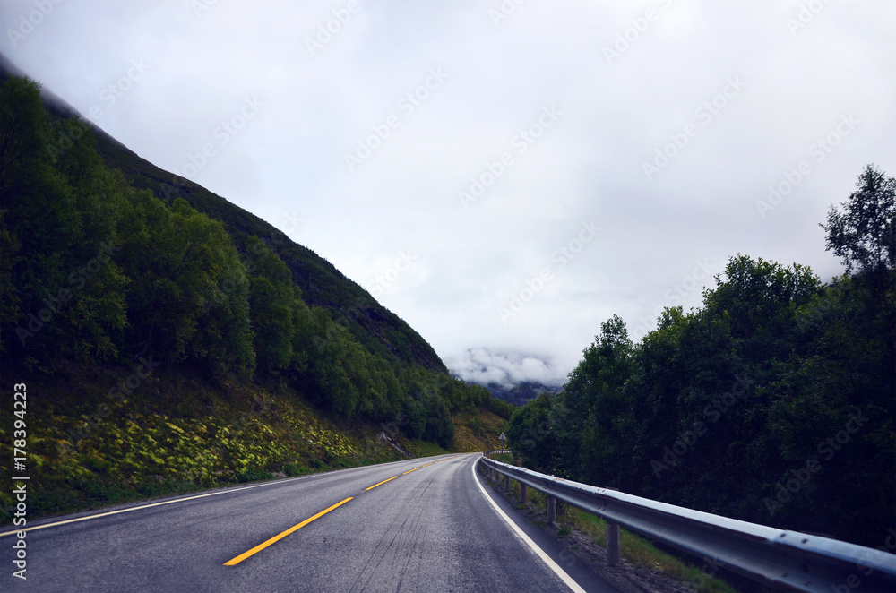 Empty road in Norway on a clouded summer day