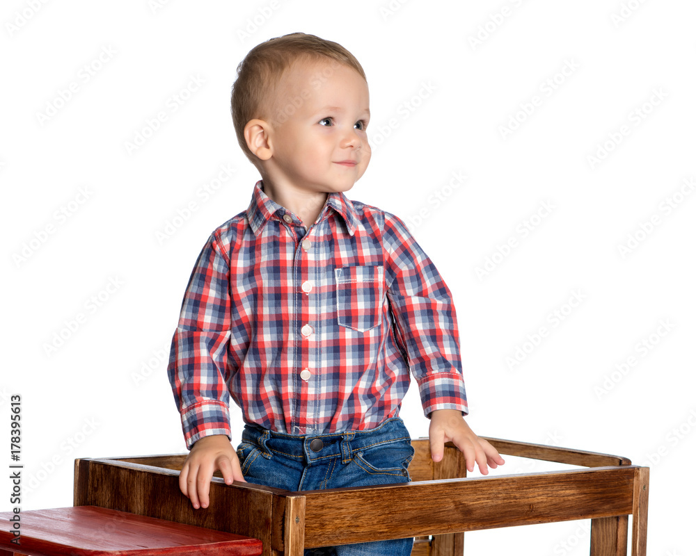 A little boy is playing with a toy car. A little boy is playing with a toy car.