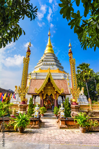 King Bumibhol stands in front of the white Chedi at Wat Chang Yu photo