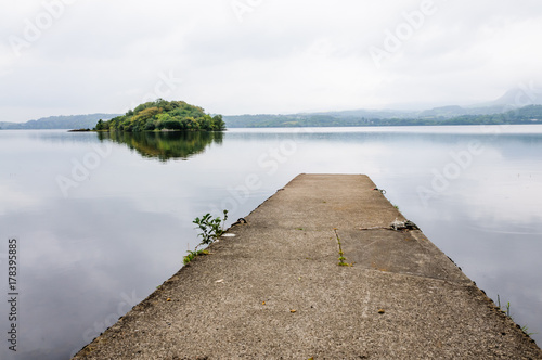 Concrete jetty at a lake with the island of Innisfree photo