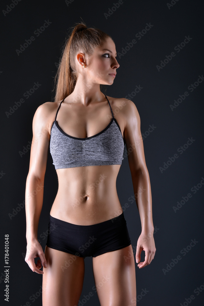 Beautiful young sporty sexy woman showing muscle Beautiful young sporty sexy woman showing muscle