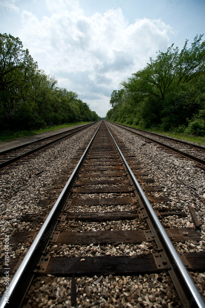 View of the railroad tracks with trees on side