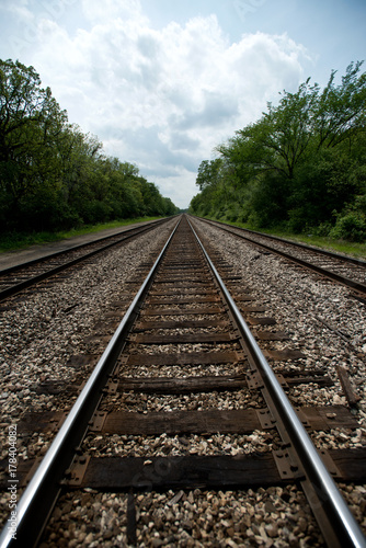 View of the railroad tracks with trees on side