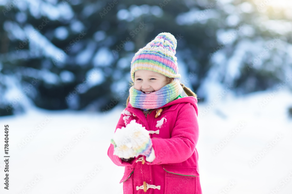 Child playing with snow in winter. Kids outdoors. Child playing with snow in winter. Kids outdoors.