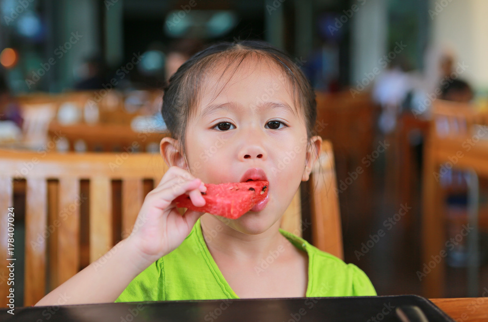 Asian little girl is drinking a water from glass after meal. Asian little girl is drinking a water from glass after meal.