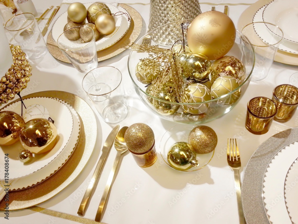 Beautiful table setting with Christmas decoration in golden color