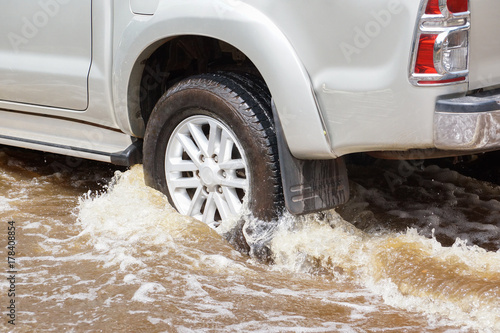 Water Splashed by a car running through a flooded road after heavy rain