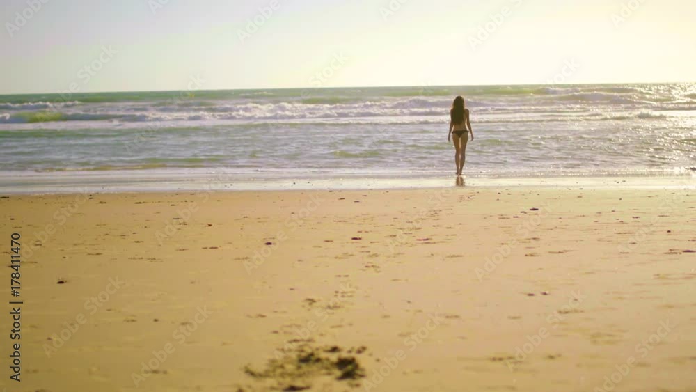 Beautiful woman in topless on beach in a sunny day Beautiful woman in topless on beach in a sunny day