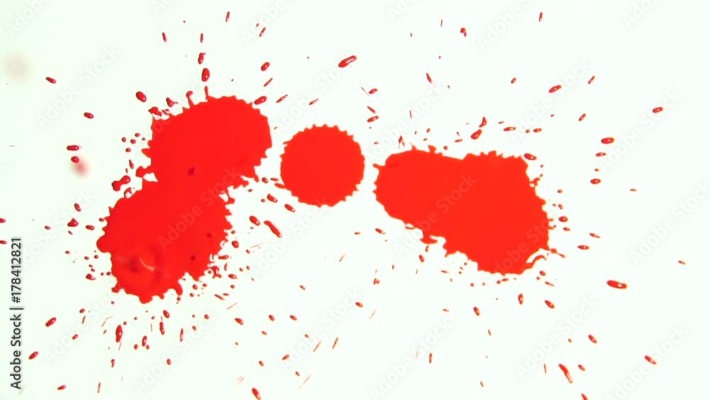 drops of red liquid dripping from above on a white background. drops of red liquid dripping from above on a white background.