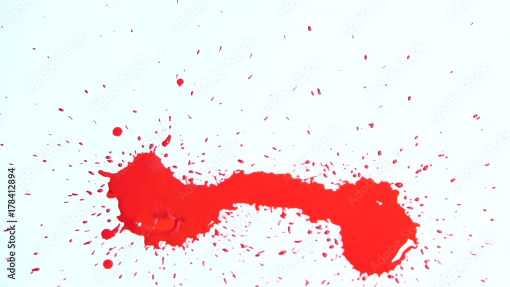 drops of red liquid dripping from above on a white background. drops of red liquid dripping from above on a white background.
