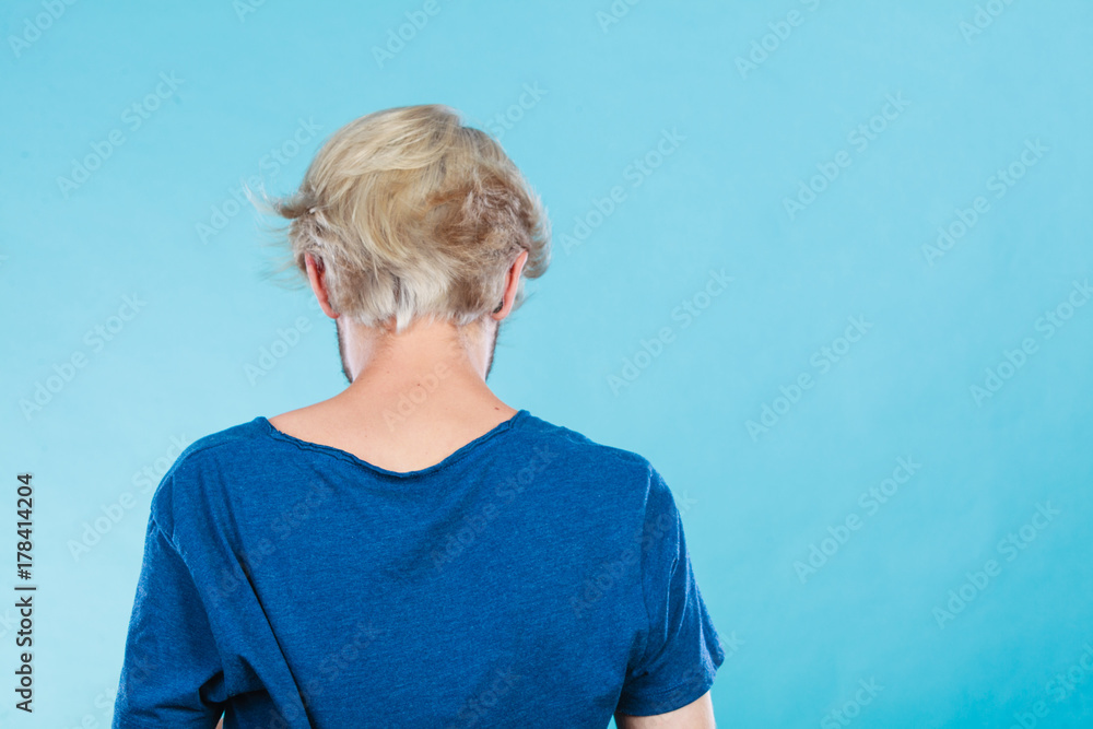 Man standing backwards in blue tshirt, male back Man standing backwards in blue tshirt, male back