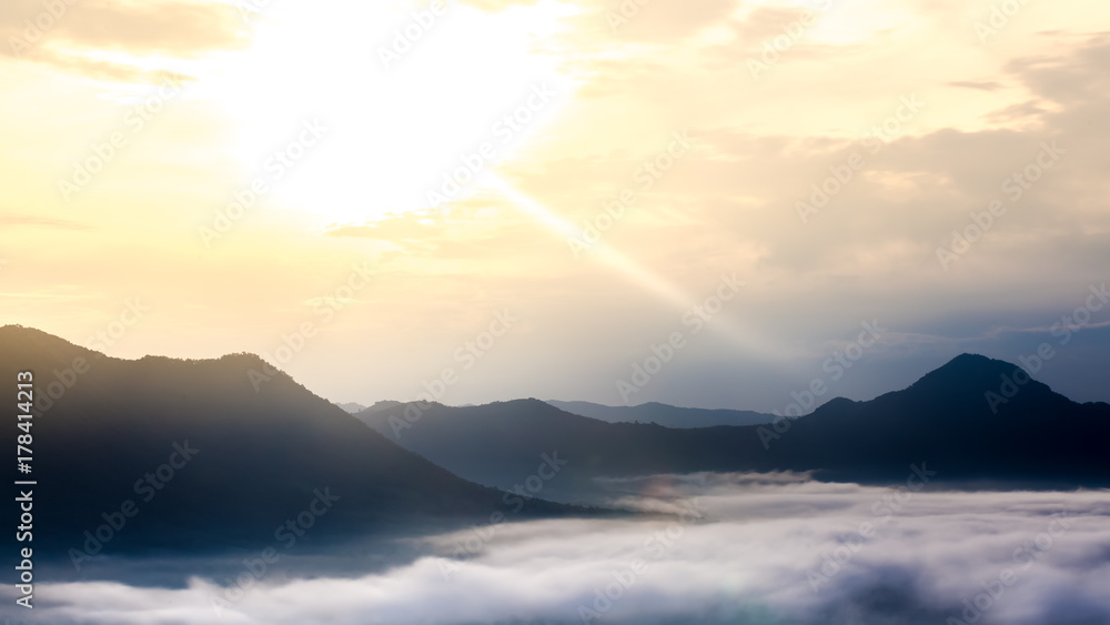 Mountain in morning sun ray and winter fog Mountain in morning sun ray and winter fog