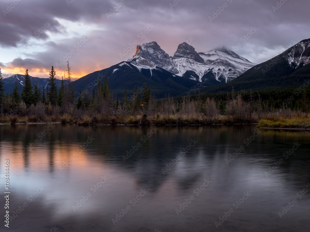 Sunrise view of the Three Sisters from Policeman's Creek along the Bow River outside Canmore, Alberta.