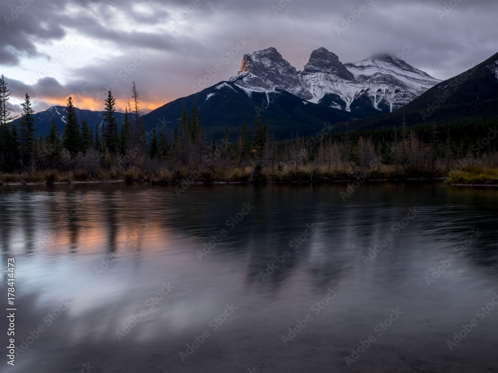 Sunrise view of the Three Sisters from Policeman's Creek along the Bow River outside Canmore, Alberta.