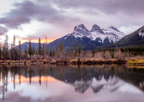 Sunrise view of the Three Sisters from Policeman's Creek along the Bow River outside Canmore, Alberta. © Jeff Whyte