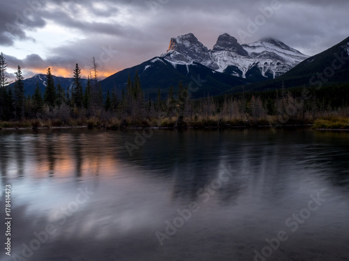 Sunrise view of the Three Sisters from Policeman s Creek along the Bow River outside Canmore  Alberta.