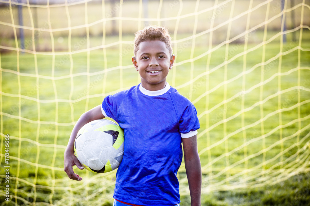 Naklejka premium Diverse young boy on a youth soccer team 