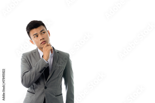 Portrait of a business man thinking with suit. Isolated on white background with copy space