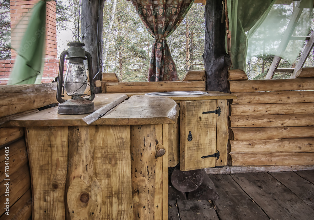 Rural kitchen in wooden gazebo