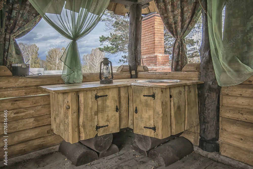 Rural kitchen in wooden gazebo