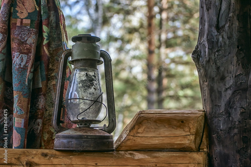 Old kerosene lamp on wooden window of gazebo