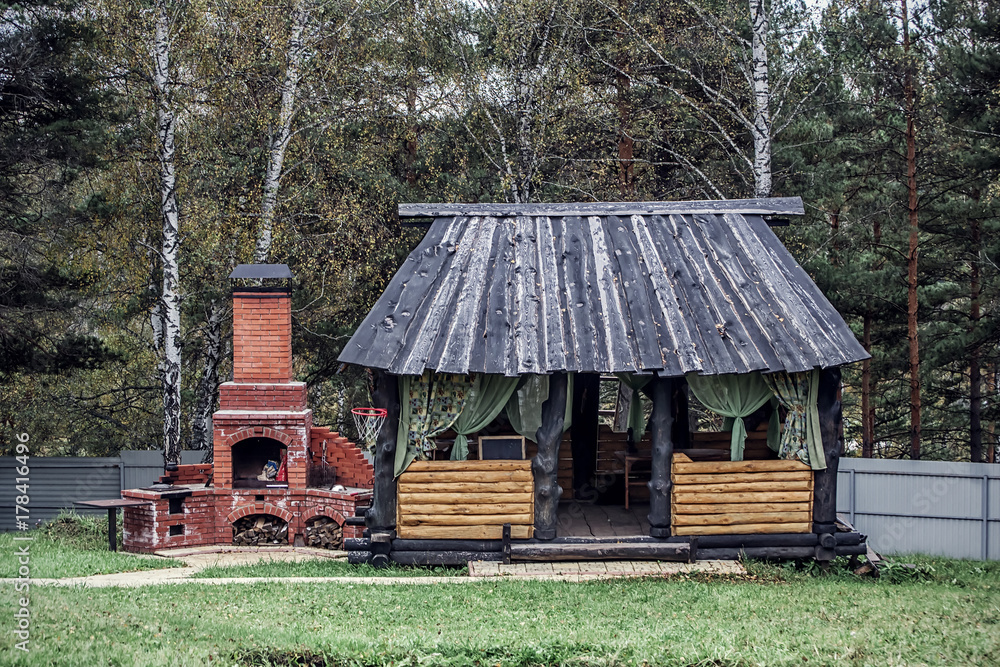 Landscape with sunny day and wooden rustic gazebo