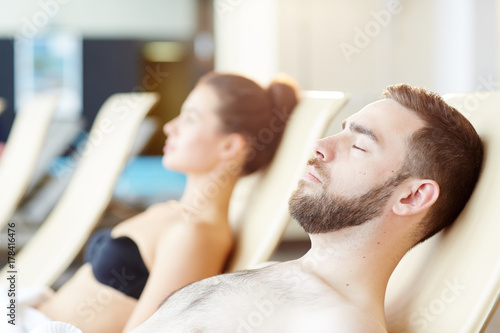 Tranquil man with his eyes closed enjoying vacation at spa resort