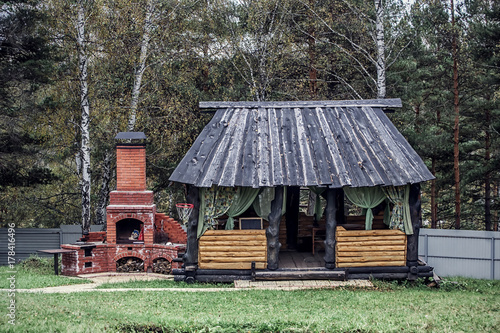 Obraz na płótnie Landscape with sunny day and wooden rustic gazebo w salonie