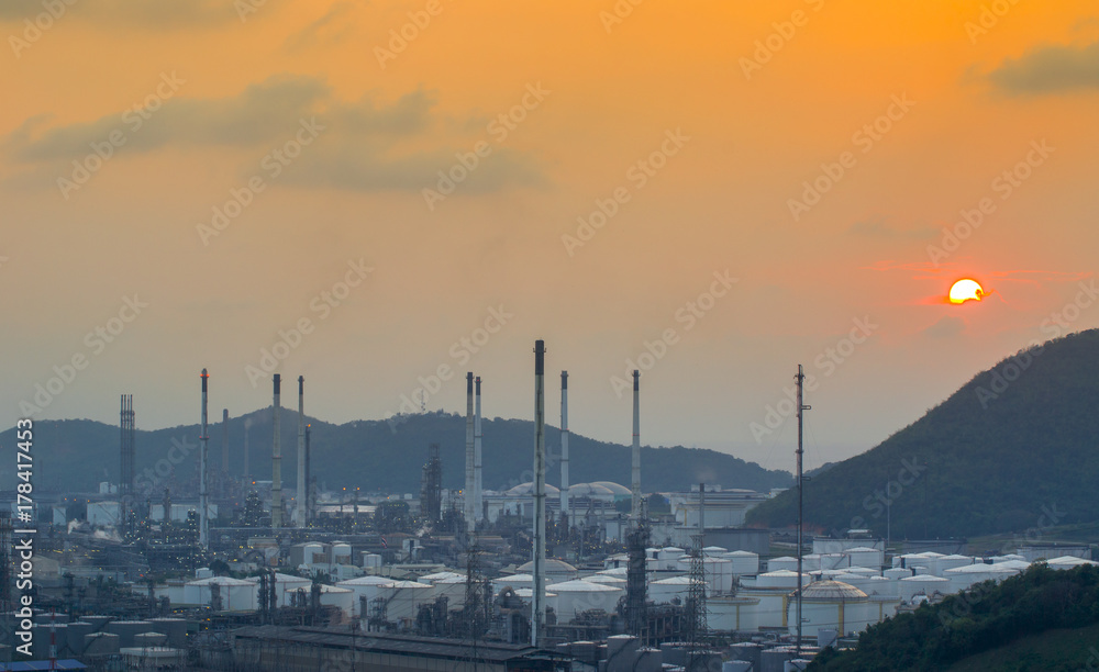 Aerial view Oil refinery with a background of mountains and sky.
