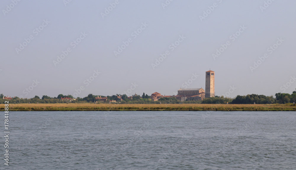 ancient bell tower of the church in the Torcello Island in Italy