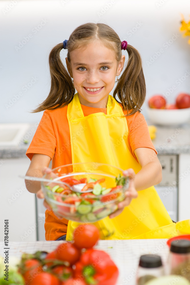 Smiling girl with a bowl of vegetable salad Smiling girl with a bowl of vegetable salad